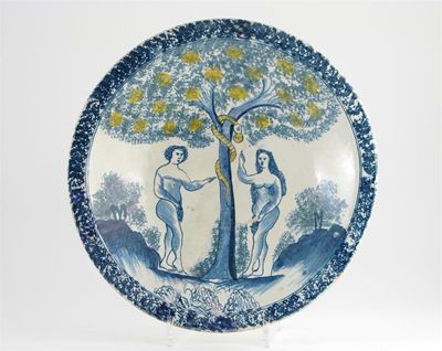 Appraisal: A Delftware Adam and Eve charger painted and sponged in