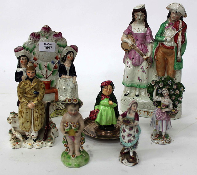 Appraisal: THREE STAFFORDSHIRE FIGURINES to include one of two minstrels together