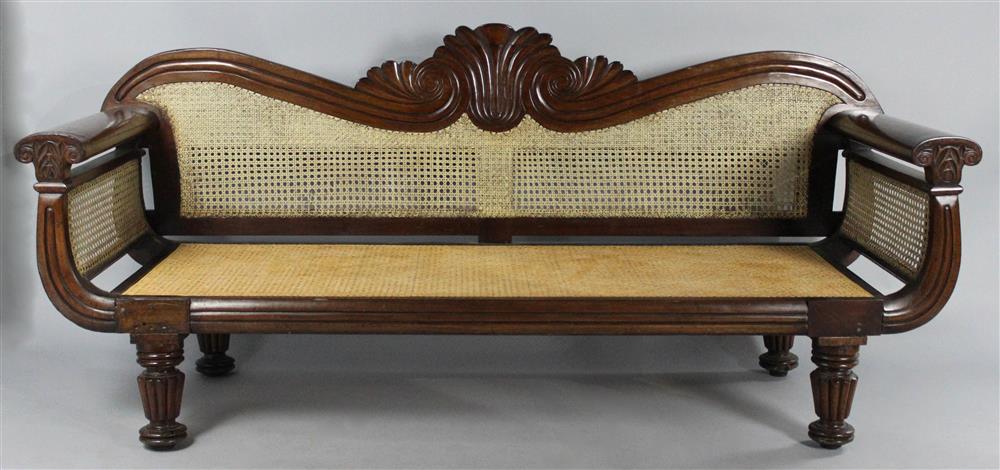 Appraisal: WEST INDIES CARVED MAHOGANY CANED SETTEE having a shaped crest