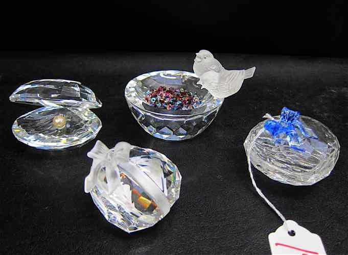 Appraisal: FOUR SWAROVSKI CRYSTAL FIGURINES ''Shell with Pearl '' ''Bird Bath