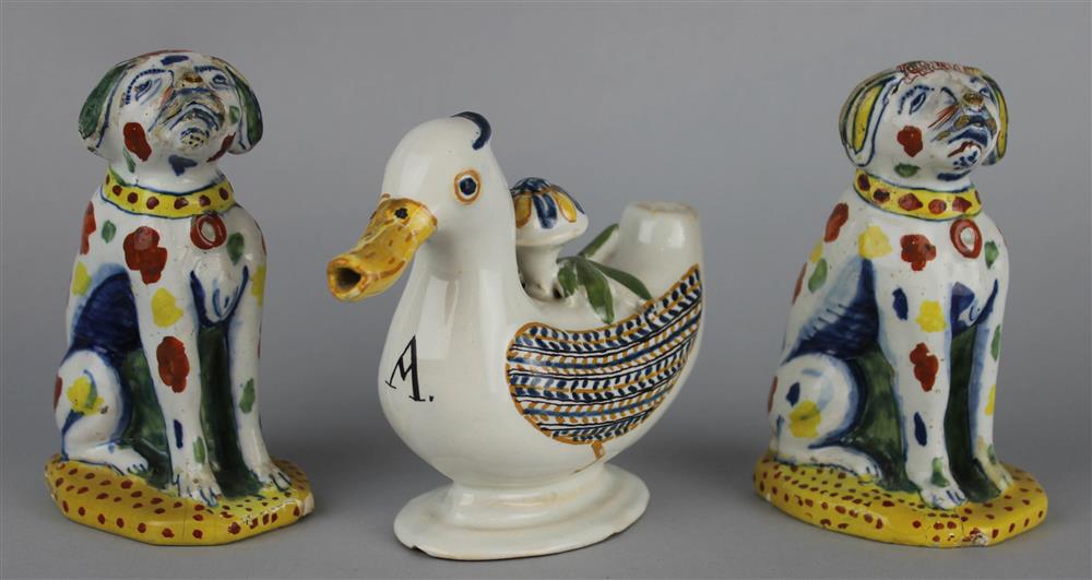 Appraisal: TWO DUTCH DELFT POLYCHROME DOGS AND A FAIENCE DUCK-FORM OIL