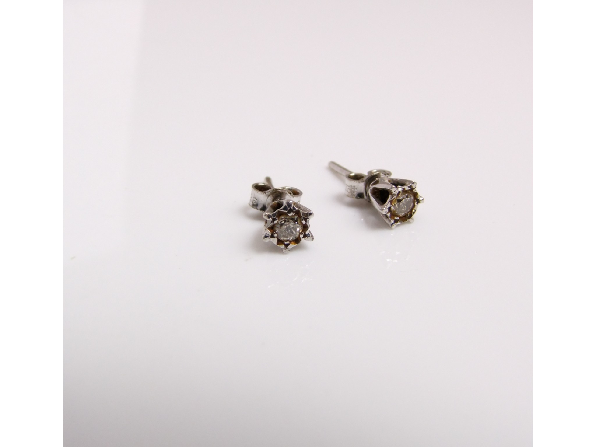 Appraisal: A pair of diamond stud earrings each set with a