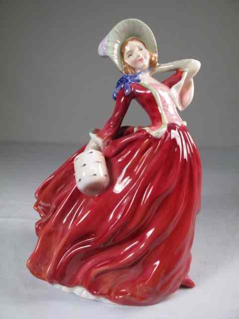 Appraisal: Royal Doulton porcelain figurine Autumn Breezes Painted and glazed Marked