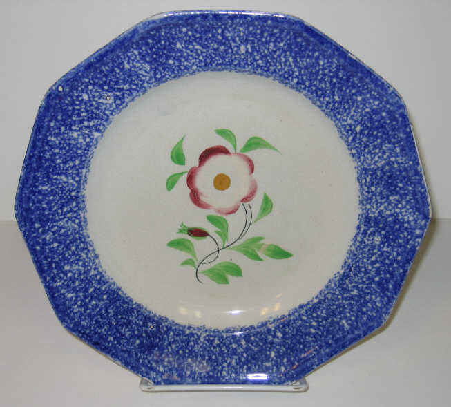 Appraisal: ENGLISH SPATTERWARE Blue spatter plate with central decorated primrose Diameter