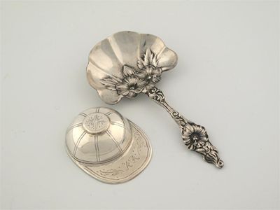 Appraisal: A metalware 'jockey cap' spoon and a caddy spoon in