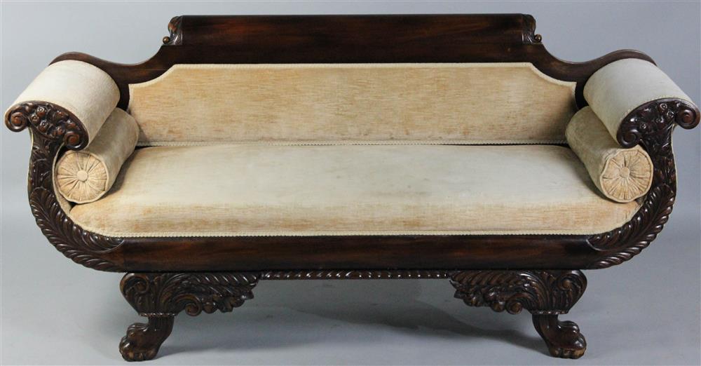 Appraisal: CLASSICAL STYLE CARVED MAHOGANY SOFA with a raised and carved