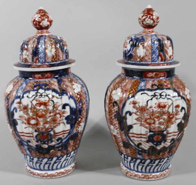 Appraisal: A pair of thC Imari vases each with ribbed shouldered