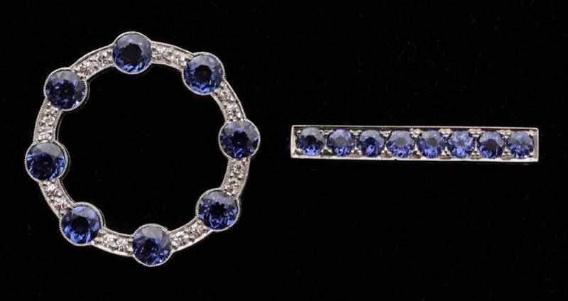 Appraisal: PLATINUM SAPPHIRE AND DIAMOND CIRCLE PIN Together with a sapphire