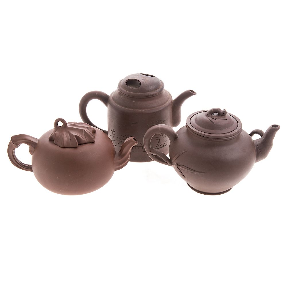 Appraisal: Three Chinese Yixing teapots including ovoid form with infuser ovoid