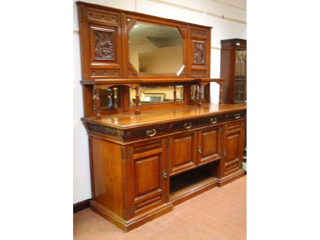 Appraisal: An Edwardian walnut sideboard by Maple Co the mirror back