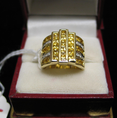 Appraisal: DIAMOND AND FOURTEEN KARAT GOLD RING set with princess-cut fancy