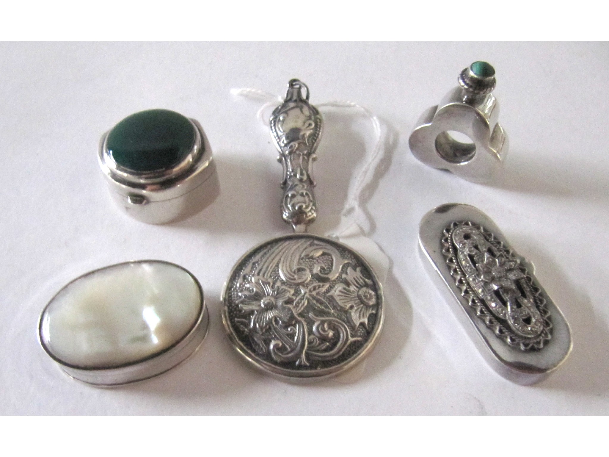 Appraisal: A lot comprising three silver pill boxes a white metal