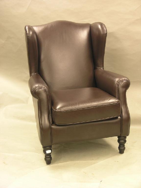 Appraisal: A modern Parker Knoll leather wing armchair on front turned