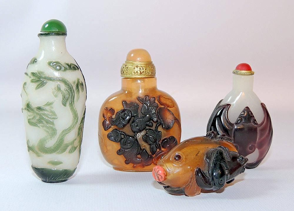 Appraisal: Four Peking Glass Snuff Bottles Four Peking glass snuff bottles