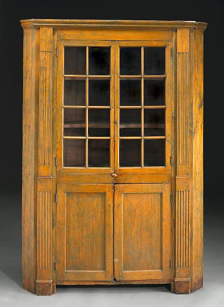 Appraisal: An American stained pine corner cupboard early th century height