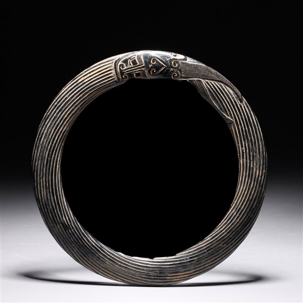 Appraisal: Unusual Chinese carved disc of rope design terminating in mask