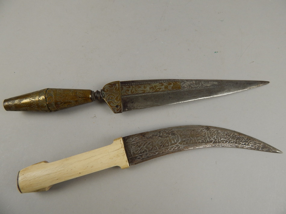 Appraisal: A thC Eastern brass and steel dagger with engraved decoration