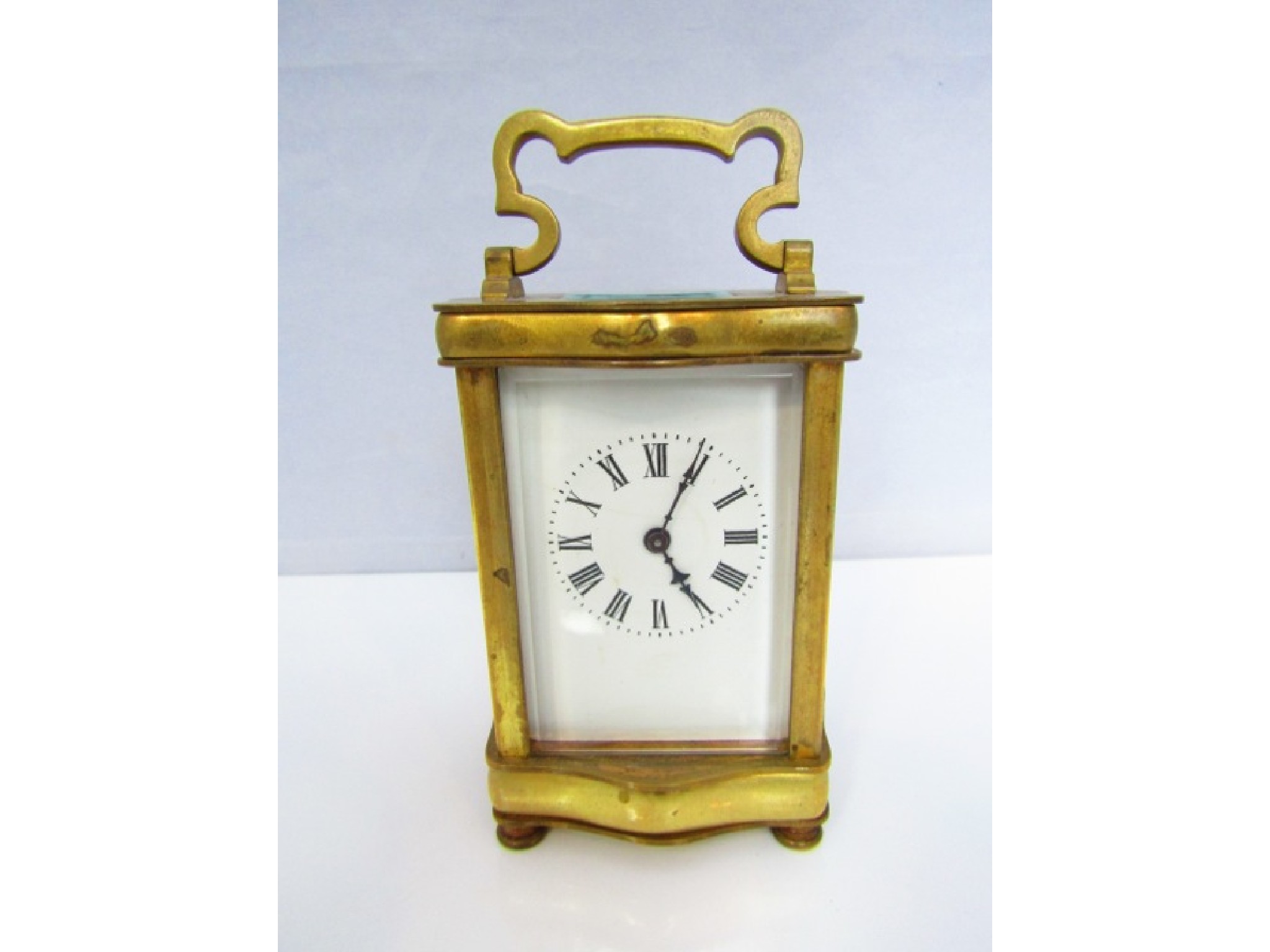 Appraisal: A brass carriage clock with enamel dial and day time