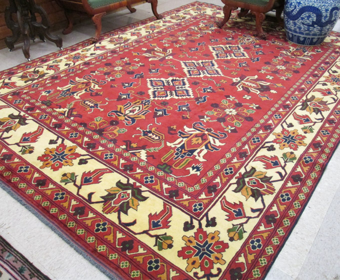 Appraisal: HAND KNOTTED ORIENTAL CARPET Pakistani Caucasian stylized floral curvilinear and