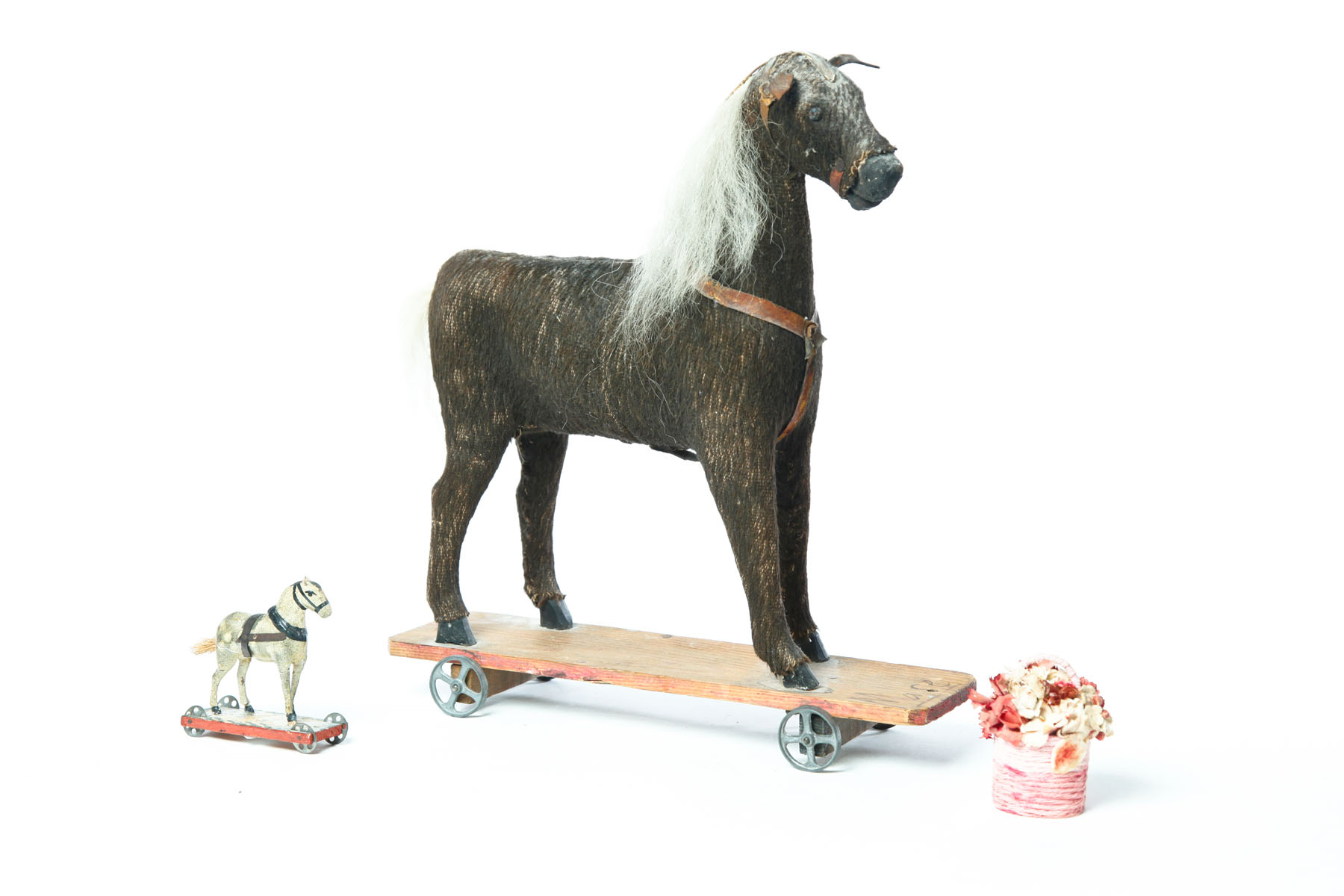 Appraisal: TWO HORSE PULL TOYS AND A FLOWER BASKET American and