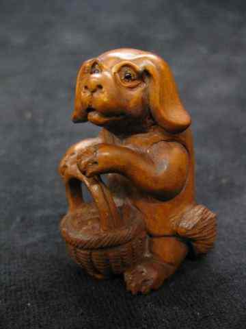 Appraisal: Carved Boxwood Netsuke of a Dog with Basket '' excellent