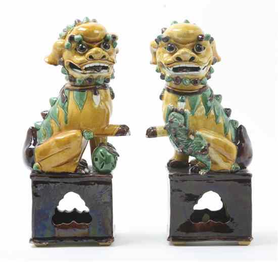 Appraisal: A Pair of Ceramic Sancai Glazed Fu Dogs depicted in