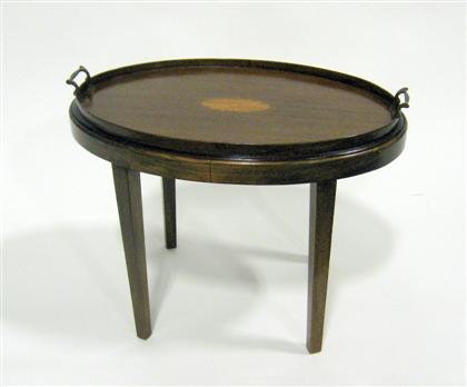 Appraisal: English mahogany tray table The oval tray with a medallion