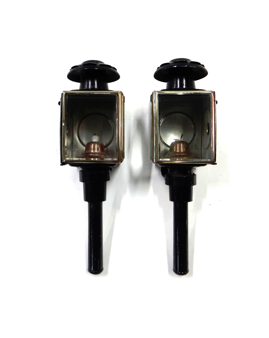 Appraisal: A pair of black painted metal coach lamps