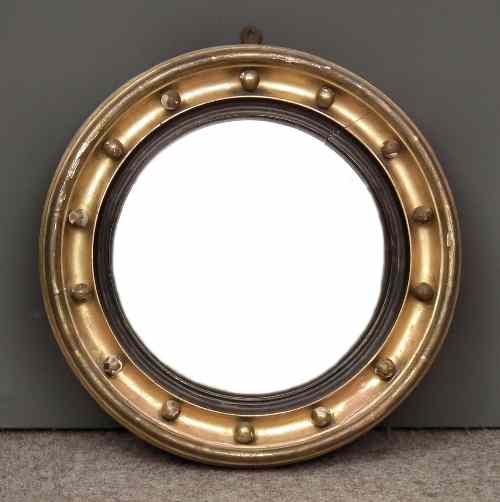 Appraisal: A gilt framed circular convex wall mirror the deep moulded