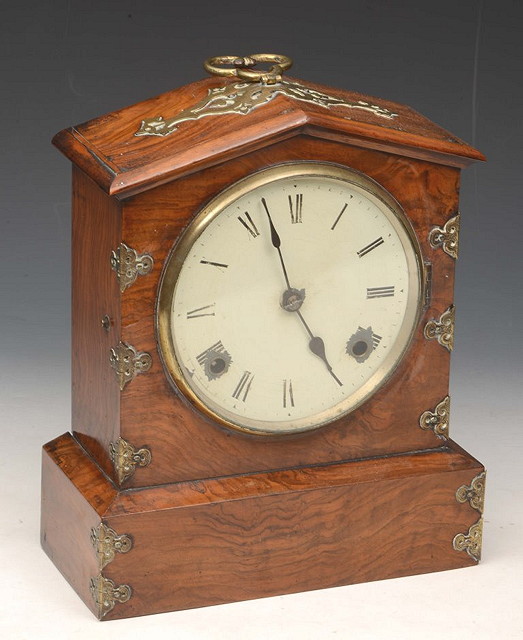 Appraisal: A VICTORIAN WALNUT ARCHED MANTEL CLOCK with striking mechanism the