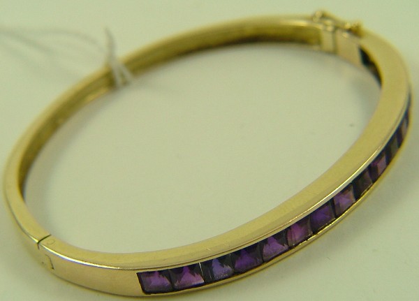 Appraisal: AMETHYST AND FOURTEEN KARAT GOLD BANGLE The bangle oval in