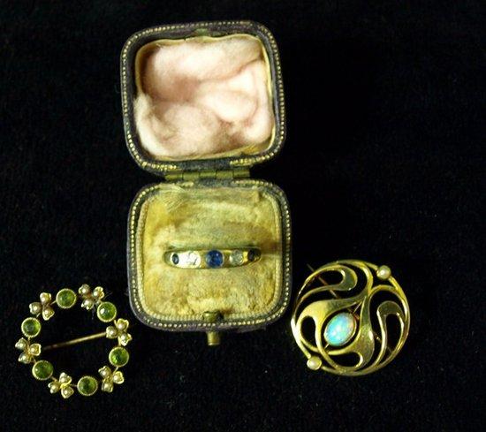 Appraisal: A circular pierced brooch set an opal a wreath type