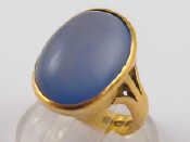 Appraisal: A carat gold ring set with a pale blue cabochon