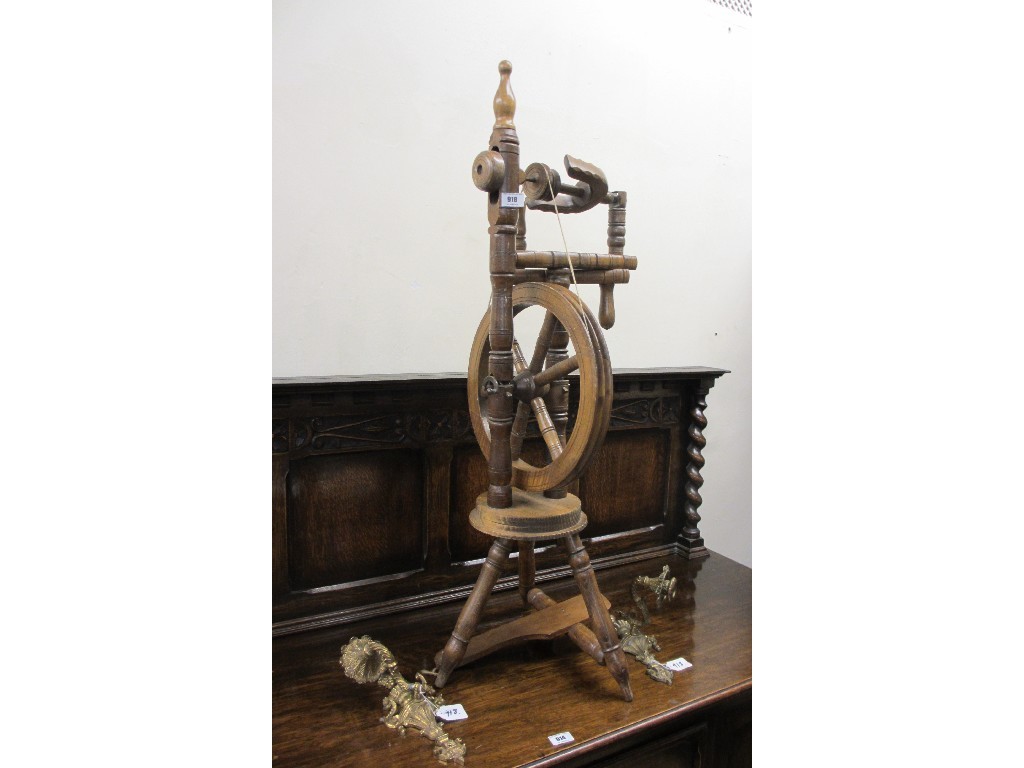 Appraisal: Spinning wheel and a pair of wall sconces