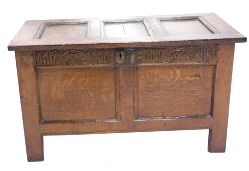 Appraisal: An thC oak coffer the three panelled top hinging to