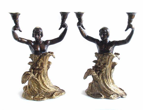 Appraisal: A pair of parcel gilt bronze figural two light candelabra