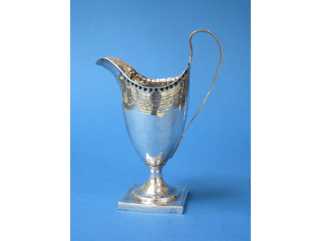 Appraisal: A George III helmet shape Cream Jug with engraved frieze