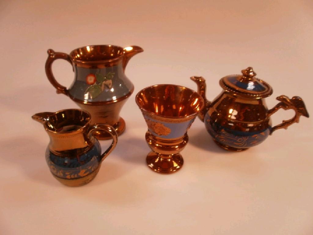 Appraisal: A small Victorian copper lustre teapot and matching jug a