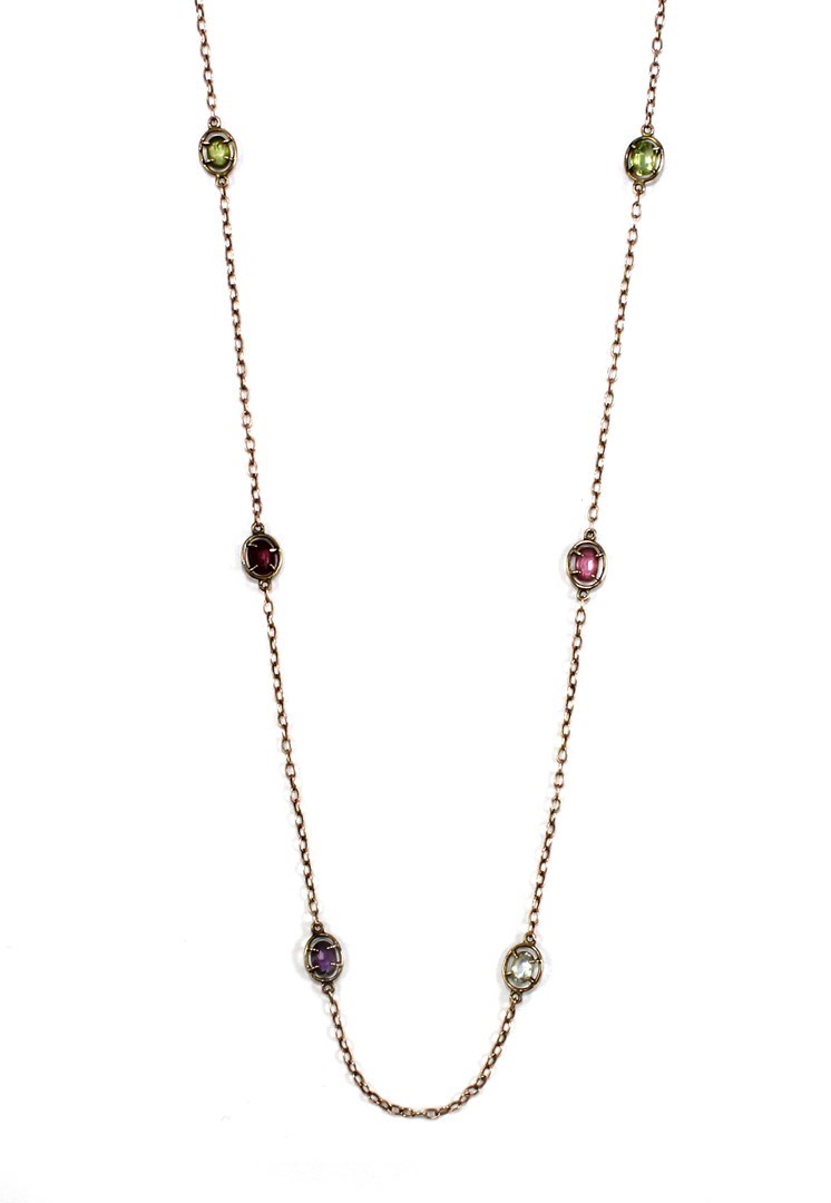 Appraisal: A gold and vary coloured gemstone set long chain of