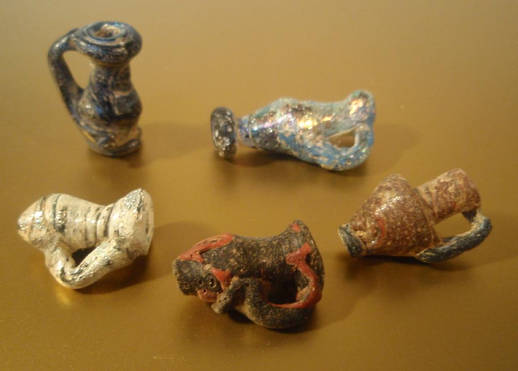 Appraisal: Three late Roman blue glass juglet pendants a fourth with