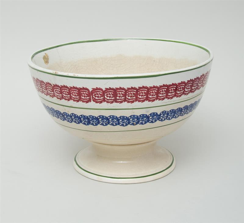 Appraisal: SPONGEWARE FOOTED PUNCH BOWL With bands of blue and red