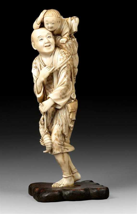 Appraisal: AN IVORY OKIMONO OF A FISHERMAN AND A LITTLE BOY