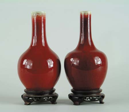 Appraisal: TWO SANG DE BOEUF BOTTLE VASES An even blood red