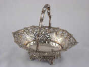 Appraisal: A Georgian silver basket with cast swing handle shaped gadrooned