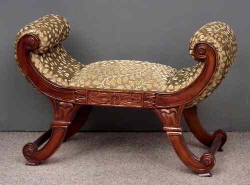 Appraisal: A mahogany stool of Regency design with curved ends upholstered