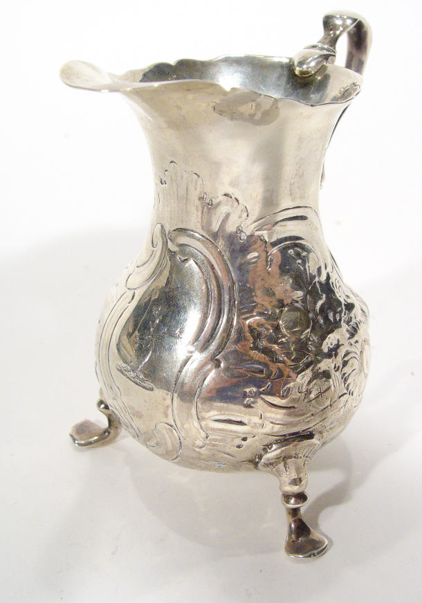 Appraisal: Georgian silver cream jug embossed and chased with flowers and