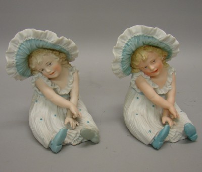 Appraisal: Pair of identical Heubach bisque girl figurines Sunburst symbol They