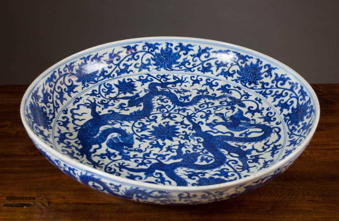 Appraisal: LARGE CHINESE BLUE AND WHITE PORCELAIN CHARGER featuring dragon motif