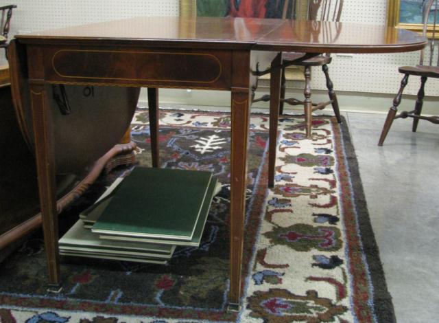 Appraisal: Banded mahogany drop-leaf dining table with six '' leaves and