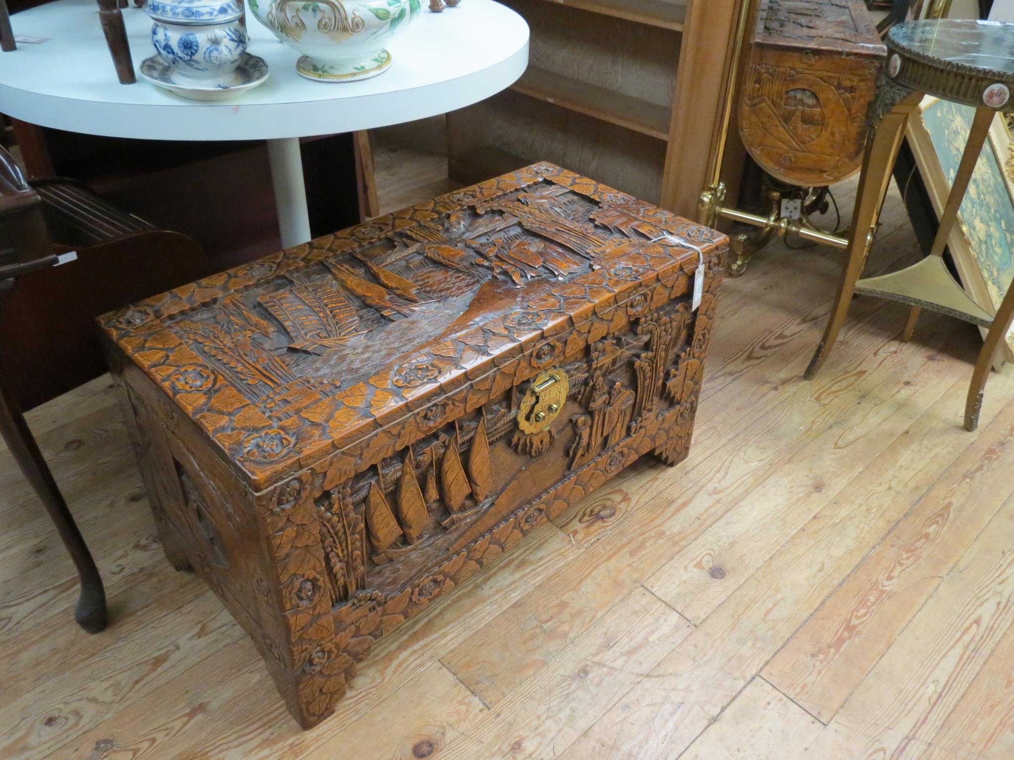 Appraisal: A Kenyon camphorwood blanket chest boldly-carved with fisher-folk ft in